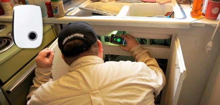 guy placing Pest Bully under sink